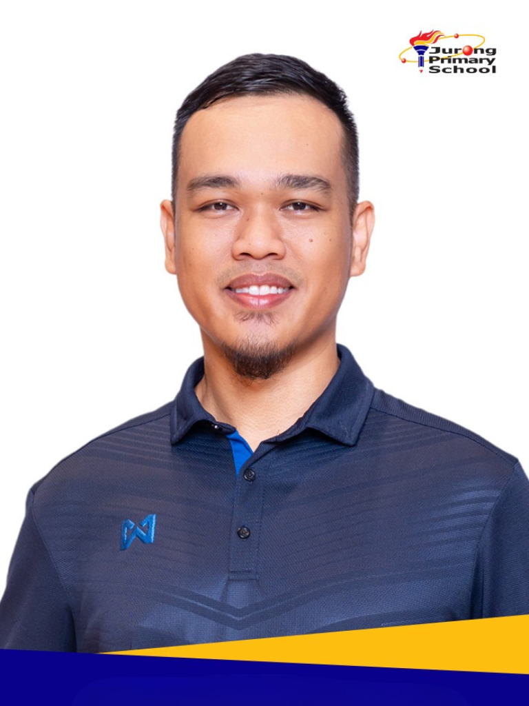 Smiling man in navy polo shirt, short dark hair, light beard.